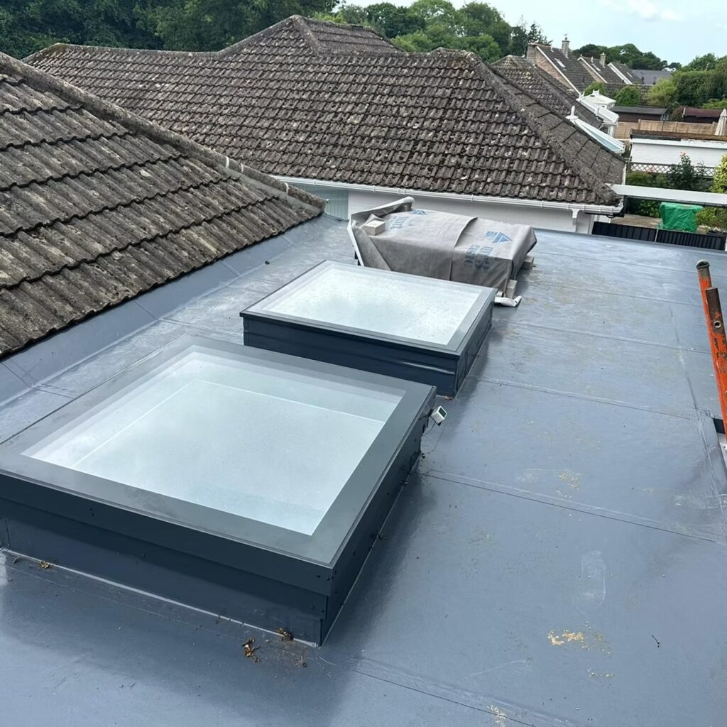 Double skylight installation on a flat roof extension by builders Winchester.